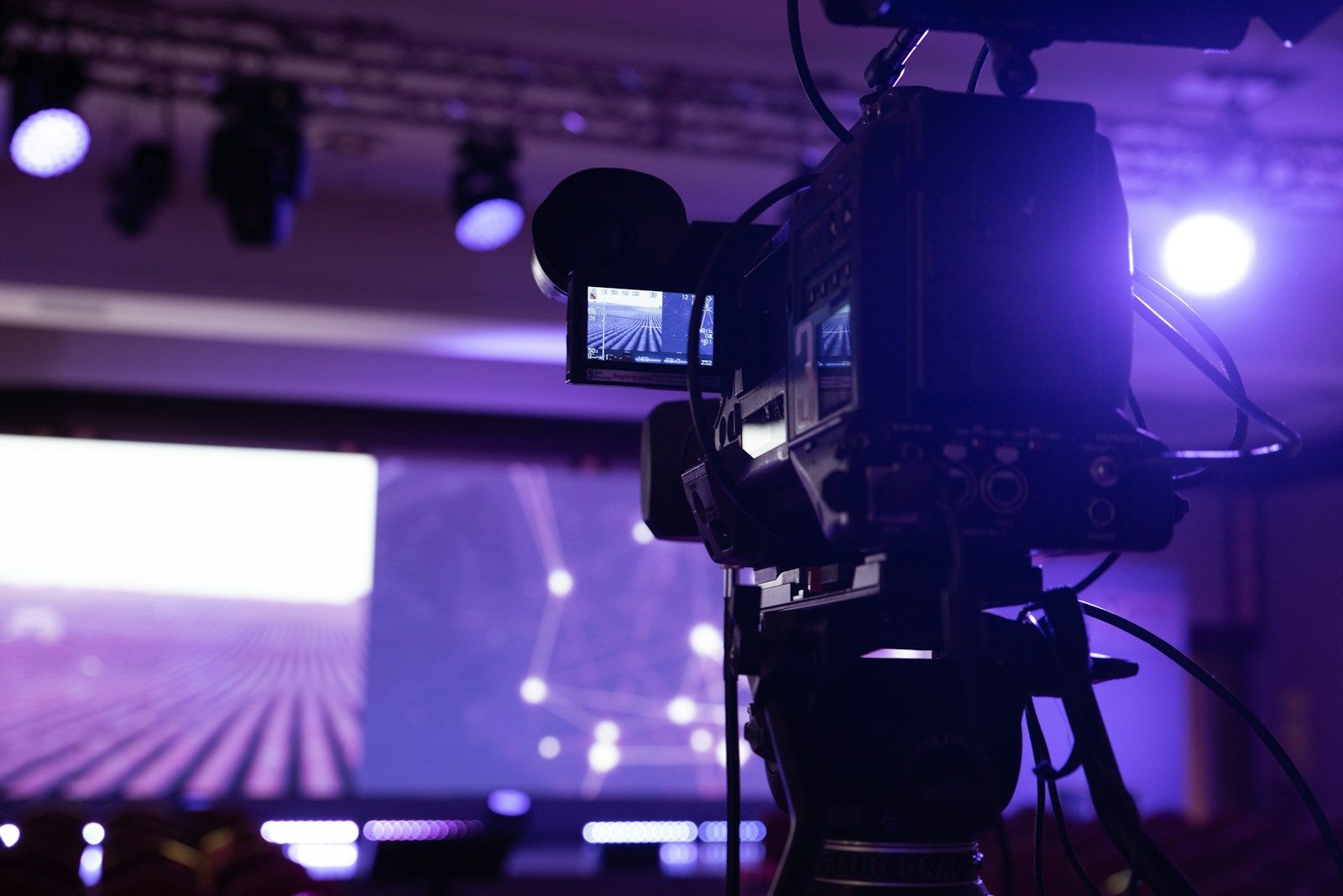 A broadcast camera filming a stage